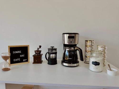 a counter with a coffee maker and other items on it at Casa Fénix in Marinilla