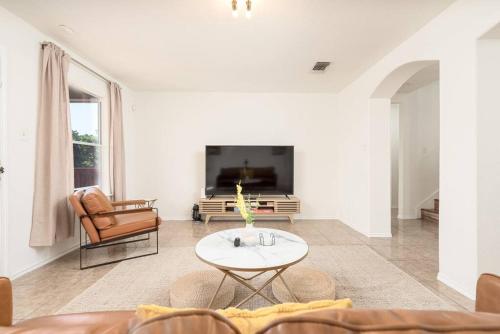 a living room with a couch and a table at Spacious 4BR w Game Room - 15 min to Seaworld in San Antonio