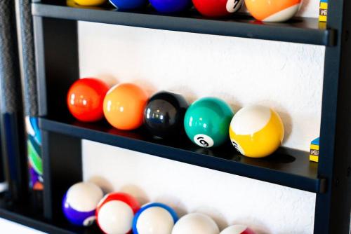 a shelf filled with different colored bowling balls at Spacious 4BR w Game Room - 15 min to Seaworld in San Antonio