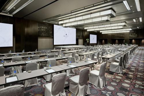 a large room with tables and chairs and a projection screen at JW Marriott Hotel Bangkok in Bangkok