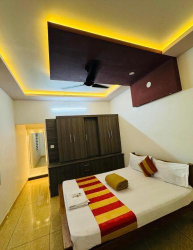 a bedroom with a large bed with a tv on the ceiling at Diamond Villa Near Rajagiri Hospital in Alwaye