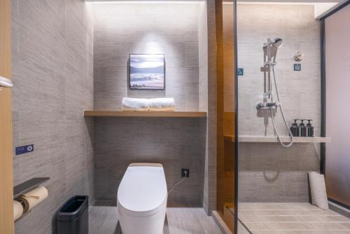 a bathroom with a toilet and a shower at Atour Hotel Changsha Xingsha Economic Development Zone Sanyi Road in Changsha