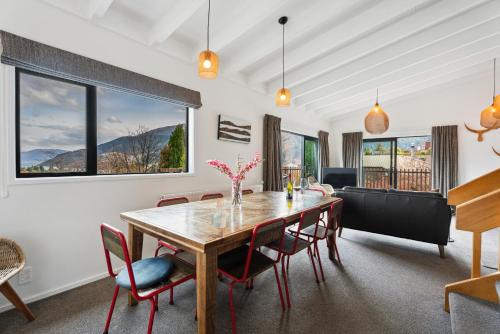 a dining room with a table and chairs at Lake and Mountain Views - Central Queenstown in Queenstown