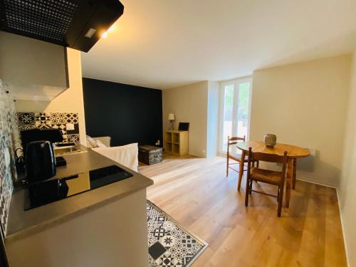 a kitchen and living room with a table and a counter at Saint Malo centre lambety in Saint Malo