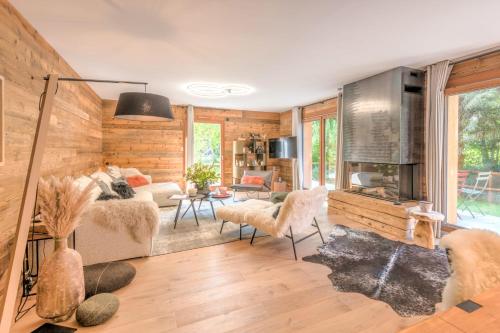 - un salon avec des boiseries et un salon avec des chaises dans l'établissement Appartement Capra - Welkeys, à Megève