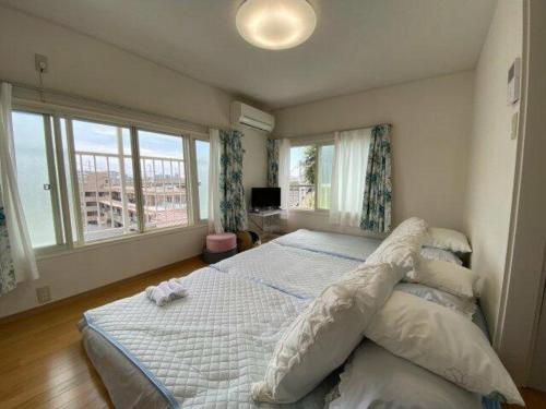 a bedroom with a bed and a large window at Tokyo downtown牡丹莊 in Tokyo