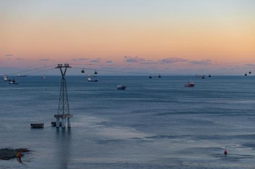 a group of boats in the water at sunset at Fairfield by Marriott Busan Songdo Beach in Busan