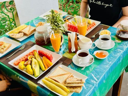 a table topped with plates of breakfast foods and drinks at Rock Grand View in Ella