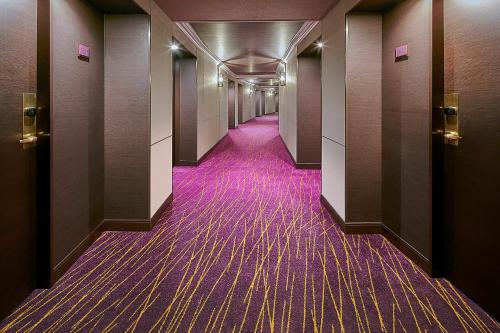 a hallway with purple carpeting in a building at Sheraton Grande Tokyo Bay Hotel in Urayasu