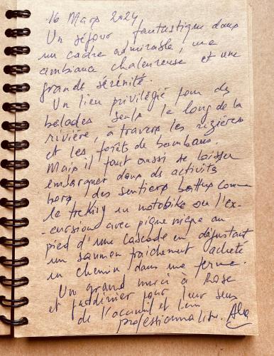 a letterzos writing on top of a notebook at maison Rose & Jardinier eco homestay in Sa Pa