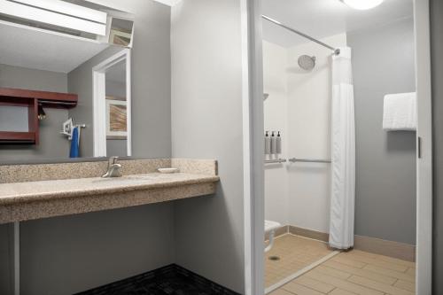 a bathroom with a sink and a shower at Courtyard Lafayette Airport in Lafayette