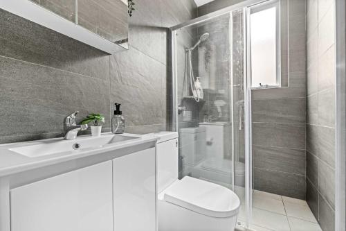 a bathroom with a toilet and a sink and a shower at Rustic Double Room - Central Location in Kensington - Shared Bathroom in Sydney