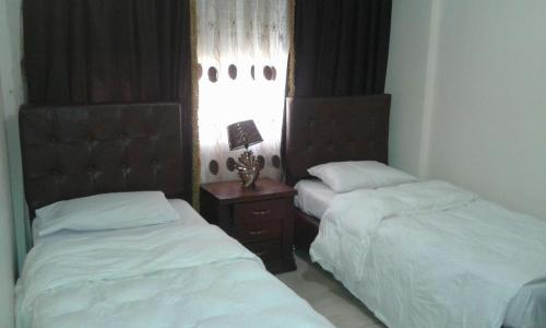 Кровать или кровати в номере Al Tawheed Hotel Apartments