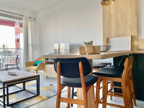 - une cuisine avec un bar avec des chaises et une table dans l'établissement 