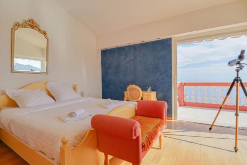 a bedroom with a bed with a view of the ocean at "Le Clos des Guillons" Piscine, Vue imprenable, Parkings in Menton