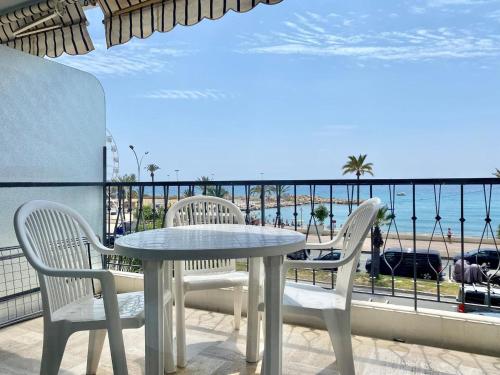 une table et des chaises sur un balcon avec vue sur l'océan dans l'établissement Le mona lisa, vue mer, balcon, à Menton