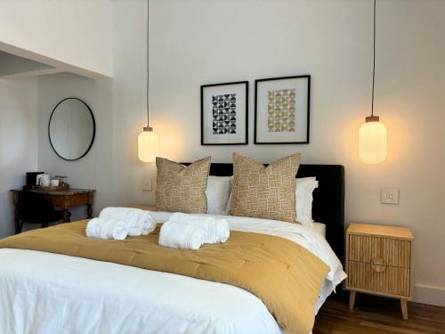 a bedroom with a large bed with towels on it at The Paarl Grand in Paarl
