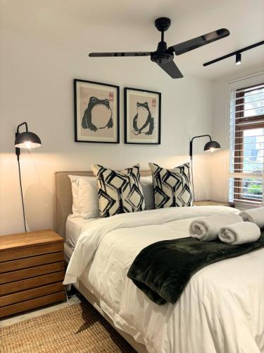 a bedroom with a bed with two lamps and two pillows at The Paarl Grand in Paarl