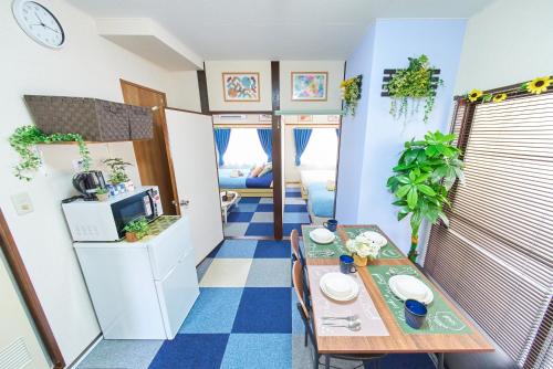 a small room with a table and a kitchen at Belmont 201 3min to Station Easy Access Ueno Asakusa Skytree Sleeps 5 in Tokyo