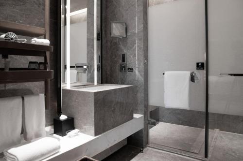 a bathroom with a sink and a mirror at Chongqing Marriott Hotel in Chongqing