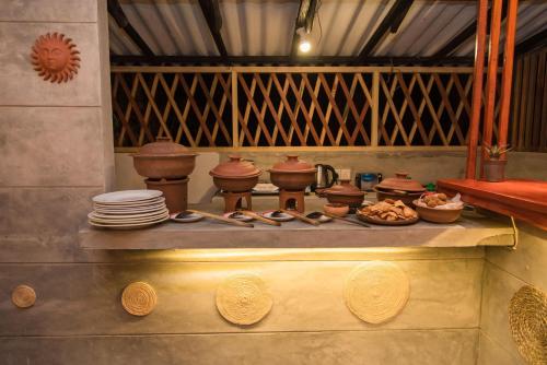 a table with plates and utensils on top of it at Inn Sea Horizon Ahungalla in Ahungalla