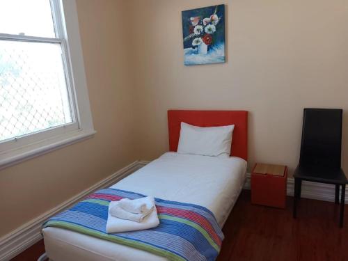 a small bedroom with a bed and a window at Converted Historic Hotel in Finley, Sleeps 25 in Finley