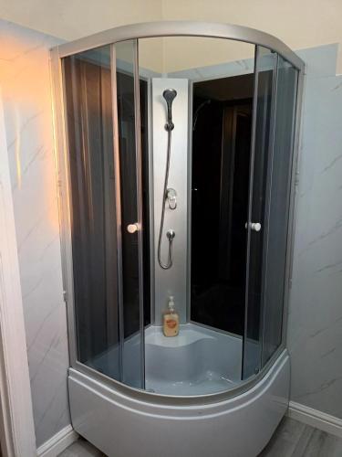 a shower with a glass enclosure in a bathroom at Converted Historic Hotel in Finley, Sleeps 25 in Finley
