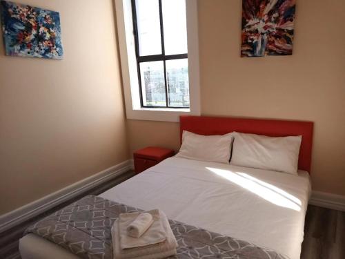 a small bedroom with a bed and a window at Converted Historic Hotel in Finley, Sleeps 25 in Finley