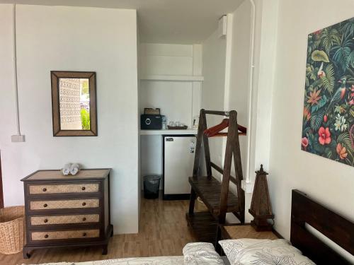 a living room with a stairway and a kitchen at Pavana Boutique & Kite Bungalows in Thongsala