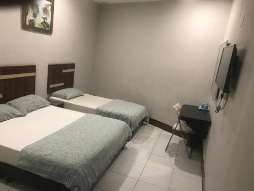 Postel nebo postele na pokoji v ubytování Ap Classic Hotel
