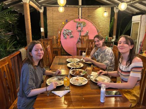 a group of people sitting at a table eating food at Inn Sea Horizon Ahungalla in Ahungalla