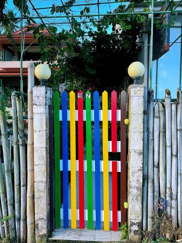 a colorful fence in front of a house at King Room with Private Bathroom and Free WiFI in SUVA CBD in The Domain