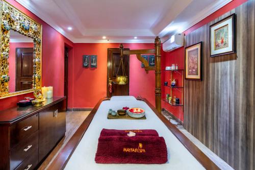 a bathroom with red walls and a bath tub at Mayfair Lagoon in Bhubaneshwar