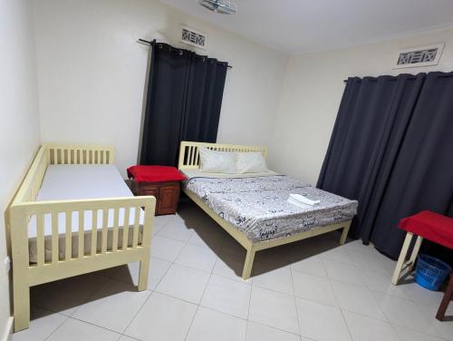 Кровать или кровати в номере JACARANDA HOMESTAY