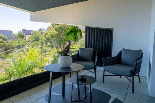 a room with two chairs and a table and a window at Suite 28 in Treilles