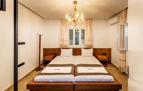 a bedroom with a bed and a chandelier at Diamante Guest House-Ground in Mağusa