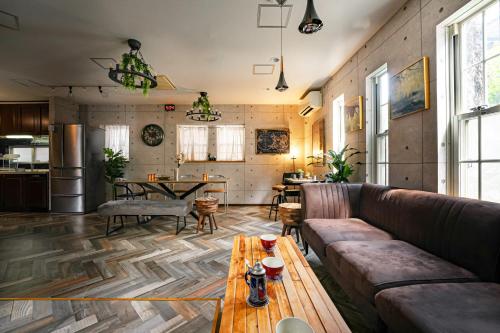 a living room with a couch and a table at Grand Piano & Shinjuku 5min walk from station in Tokyo