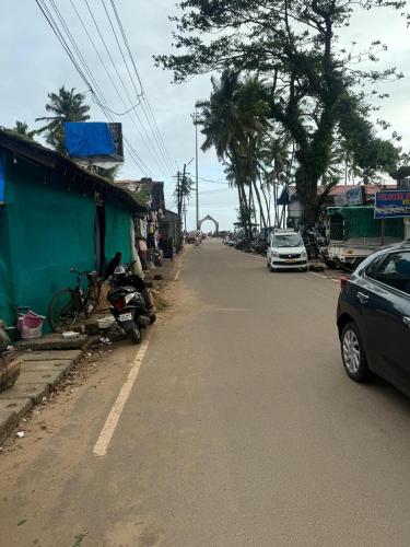 a street with cars parked on the side of the road at Casanova by the Sea - Just a walk away to Canacona Beach in Palolem