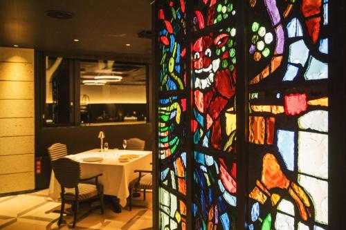 a room with a table and a stained glass window at KANAYA RESORT HAKONE in Hakone