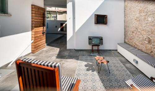 a living room with a couch and a tv at Diamante Guest House-Ground in Mağusa