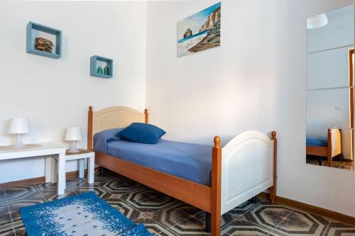 a bedroom with a bed and a table and a desk at Dimora del Pittore, Usellus in Usellus