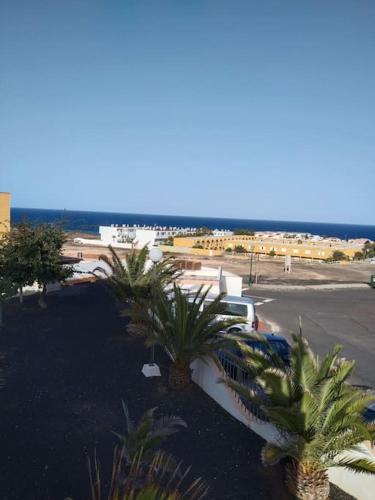 a view of a parking lot with palm trees at Incantevole appartamento con piscina e stupenda vista mare in Costa de Antigua