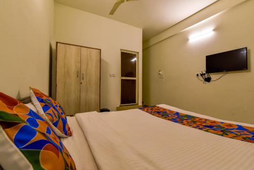 a bedroom with a bed and a flat screen tv at Rosa Bella Resort-TBV in Calangute