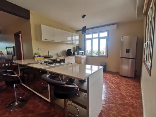 a kitchen with a counter and a stove top oven at Apartment 3bedrooms 2bathrooms rooftop jacuzzi in Pointe aux Sable