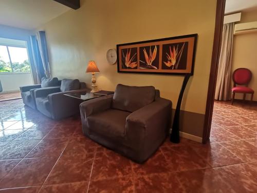 a living room with a couch and a chair at Apartment 3bedrooms 2bathrooms rooftop jacuzzi in Pointe aux Sable