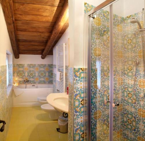 a bathroom with a shower and a toilet and a sink at Hotel Villa Rizzo Resort and Spa in San Cipriano Picentino