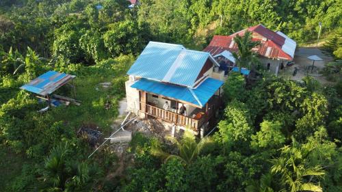 an overhead view of a house with a blue roof at Raja Ampat Family Guest House in Saonek