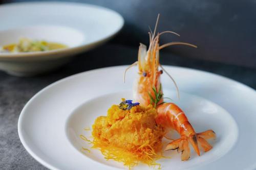 a shrimp on a white plate on a table at Shenzhen FY Hotel in Shenzhen