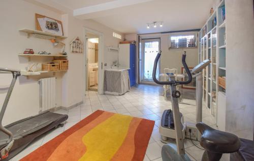 a fitness room with a gym with a treadmill at Cozy Home In Venafro With Wifi in Venafro