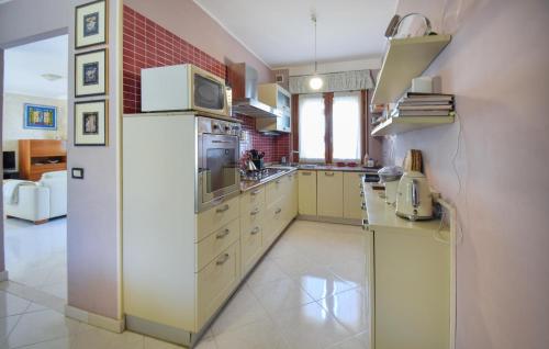 a kitchen with a refrigerator and a microwave at Cozy Home In Venafro With Wifi in Venafro